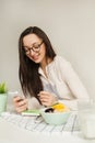 Woman making notes in notepad with healthy food on table Royalty Free Stock Photo