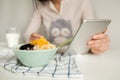 Woman making notes in notepad with healthy food on table Royalty Free Stock Photo