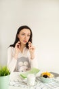 Woman making notes in notepad with healthy food on table Royalty Free Stock Photo