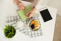 Woman making notes in notepad with healthy food on table Royalty Free Stock Photo