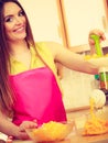 Woman making orange juice in juicer machine Royalty Free Stock Photo