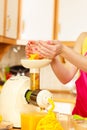 Woman making orange juice in juicer machine Royalty Free Stock Photo