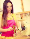 Woman making orange juice in juicer machine Royalty Free Stock Photo