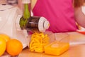 Woman making orange juice in juicer machine Royalty Free Stock Photo