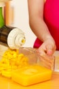 Woman making orange juice in juicer machine Royalty Free Stock Photo