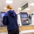 Woman Making Payment At An Automatic Check Out in Waitrose Supermarket Royalty Free Stock Photo