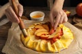 Woman making peach pie at table, closeup