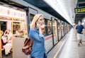 Woman making phone call at the underground platform Royalty Free Stock Photo