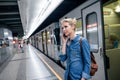 Woman making phone call at the underground platform Royalty Free Stock Photo