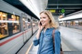 Woman making phone call at the underground platform, waiting Royalty Free Stock Photo