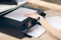 Woman making photocopy using copier in office