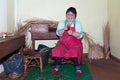 Woman is making reed furniture in a braiding factory at Madeira, Portugal.