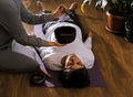 Woman making relaxing massage for young man.  Meditation, sound therapy with Tibetan singing bowls Royalty Free Stock Photo