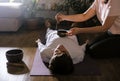 Woman making relaxing massage for young man. Meditation, sound therapy with Tibetan singing bowls