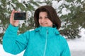 Woman is making a salfi in snowy forest Royalty Free Stock Photo