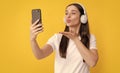 woman making selfie on smartphone. listening to music. blow kiss. influencer blogging.