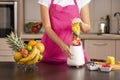 Woman making smoothie in a blender Royalty Free Stock Photo