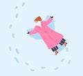 Woman making snow angel on winter holiday. Girl in coat, lying in snowdrift, top down view. Wintertime vacation fun