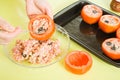 Woman making stuffed tomato