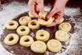 Woman making donuts and munchkins from raw yeast dough Royalty Free Stock Photo