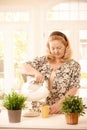 Woman making tea in kitchen Royalty Free Stock Photo