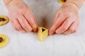 Woman making triangular cookie for jewish holiday Purim