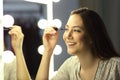 Woman making up eyelashes in a mirror Royalty Free Stock Photo