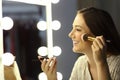 Woman making up using a brush Royalty Free Stock Photo