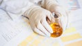 Woman making urine test with ph material in laboratory