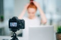 Woman making a video for her blog on hairstyle using camera Royalty Free Stock Photo