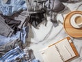 Woman is making daily to do list and schedule on notebook the organization of wardrobe in a closet.