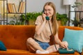 Woman making wired old-fashioned retro vintage telephone talking conversation with friends at home Royalty Free Stock Photo