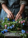 Woman making a wreath of fresh wild flowers and herbs for midsummer celebration. Florist working. Generative AI