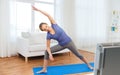 Woman making yoga bikram triangle pose on mat