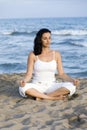 Woman making yoga exercise on the beach Royalty Free Stock Photo