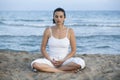 Woman making yoga exercise on the beach Royalty Free Stock Photo