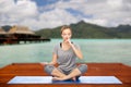 Woman making yoga in and meditating lotus pose Royalty Free Stock Photo