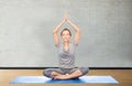 Woman making yoga meditation in lotus pose on mat Royalty Free Stock Photo