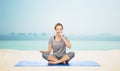 Woman making yoga meditation in lotus pose on mat Royalty Free Stock Photo