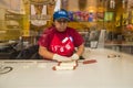 Woman makingp Pretzel dogs in a store window Royalty Free Stock Photo