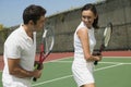 Woman and male tennis instructor practising racket control on tennis court