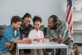 Woman and man in army uniform with their children