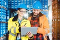 Woman and man as workers in logistics center using computer Royalty Free Stock Photo