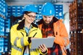 Woman and man as workers in logistics center using computer Royalty Free Stock Photo