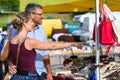 Woman and man buying stuff on flea market