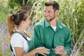 woman and man caring for plants