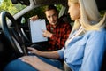 Woman and man with checklist, driving school Royalty Free Stock Photo