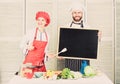 Woman and man chef hold blackboard copy space. Job position. Cooking delicious meal recipe. Cooking menu for today. List Royalty Free Stock Photo