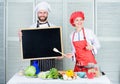 Woman and man chef hold blackboard copy space. Job position. Cooking delicious meal recipe. Cooking menu for today. List Royalty Free Stock Photo