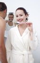 Woman and man cleaning their teeth in bathroom Royalty Free Stock Photo